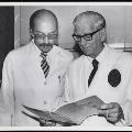 Image of WA and colleague looking at Annals of Surgery 