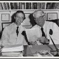Image of WA and colleague looking at article