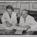 Image of WA and colleague looking at chart