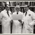 Image of WA and colleagues reading a chart